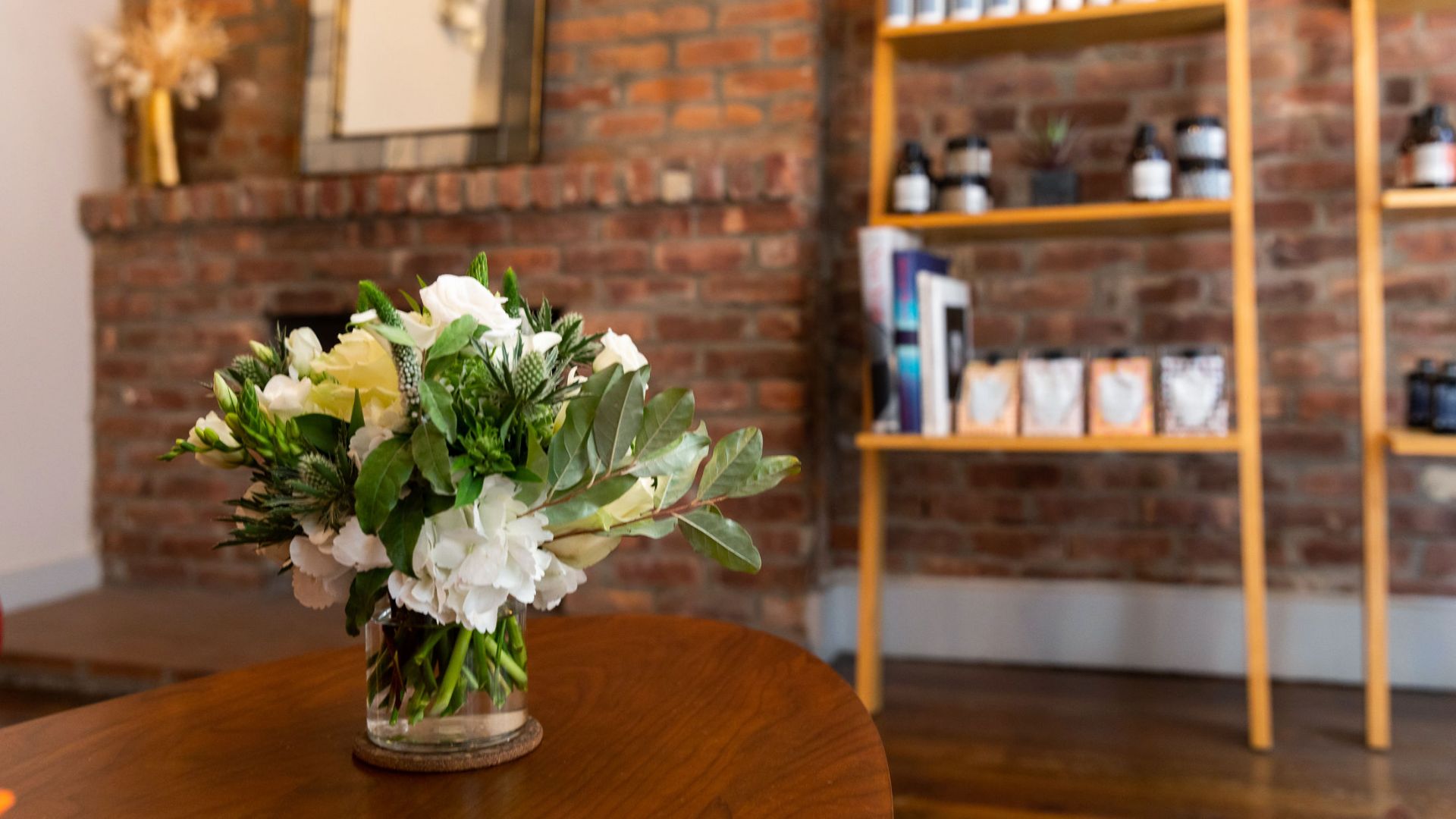 West Village salon reception area with floral arrangement